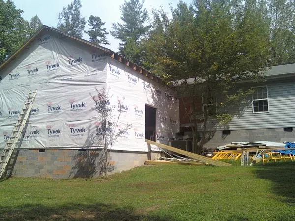 Tyvek wrapped gable on a new room addition beside an existing home in Cassoday